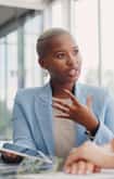 Female office employee engaged in a discussion with another female colleague 