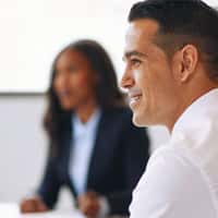 A close up of a male in business clothes with a smiling face. 